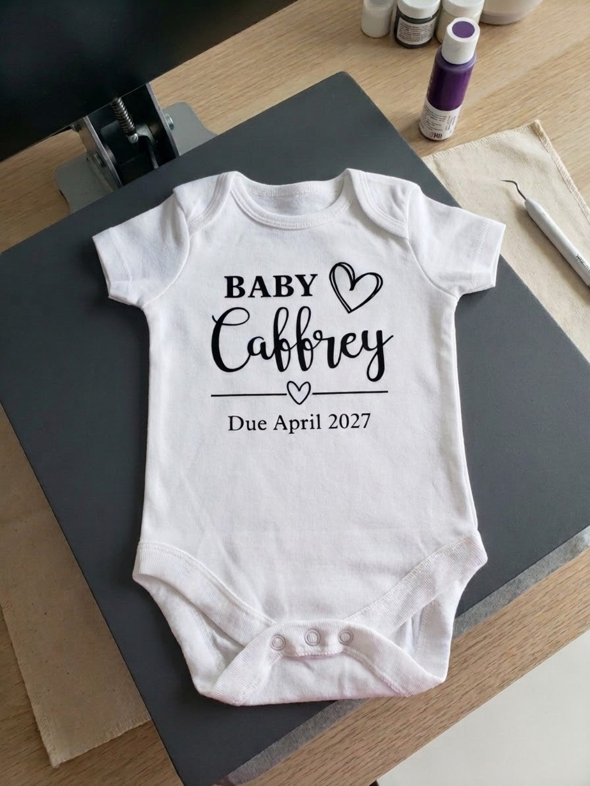 Personalised baby announcement vest with custom family name and due month