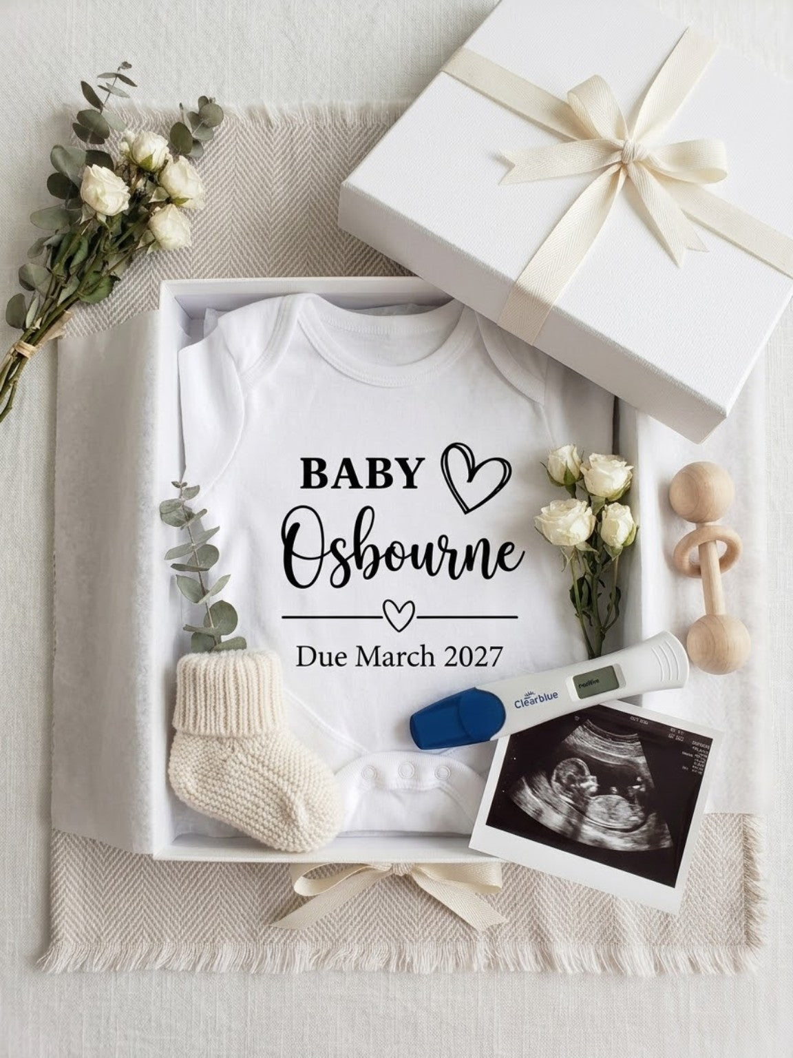 Personalised pregnancy announcement baby vest displayed in gift box