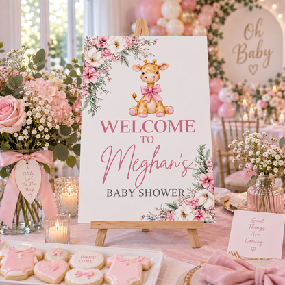 Pink giraffe baby shower sign displayed on tabletop wooden easel